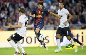 Cesc Fabregas (C) of Barcelona vies for