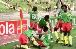 Cameroon's forward Roger Milla (9) is congratulate