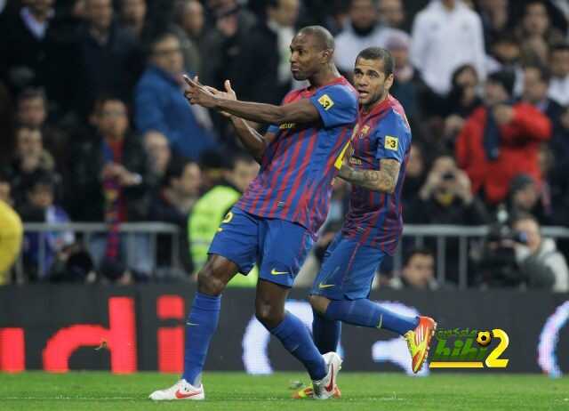 FC Barcelona's Eric Abidal from France, left, celebrates with Daniel Alves from Brazil after scoring against Real Madrid during a Copa del Rey quarter final, 1st leg soccer match at the Bernabeu stadium in Madrid Wednesday, Jan. 18, 2012. (AP Photo/Paul White)